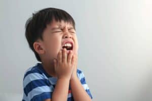A young boy in pain due to toothache